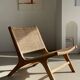 Reclining armchair in natural wood and woven rattan