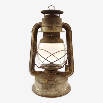 Old oil lantern in metal and glass