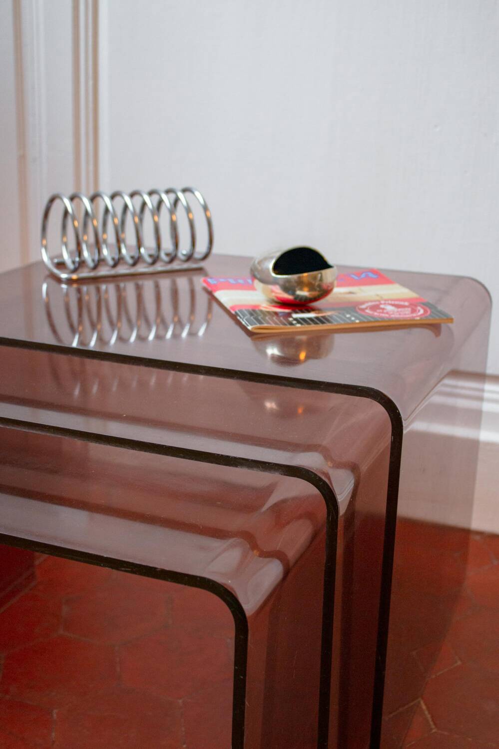 Vintage trio of nesting tables in smoked plexiglass by Michel Dumas, year.