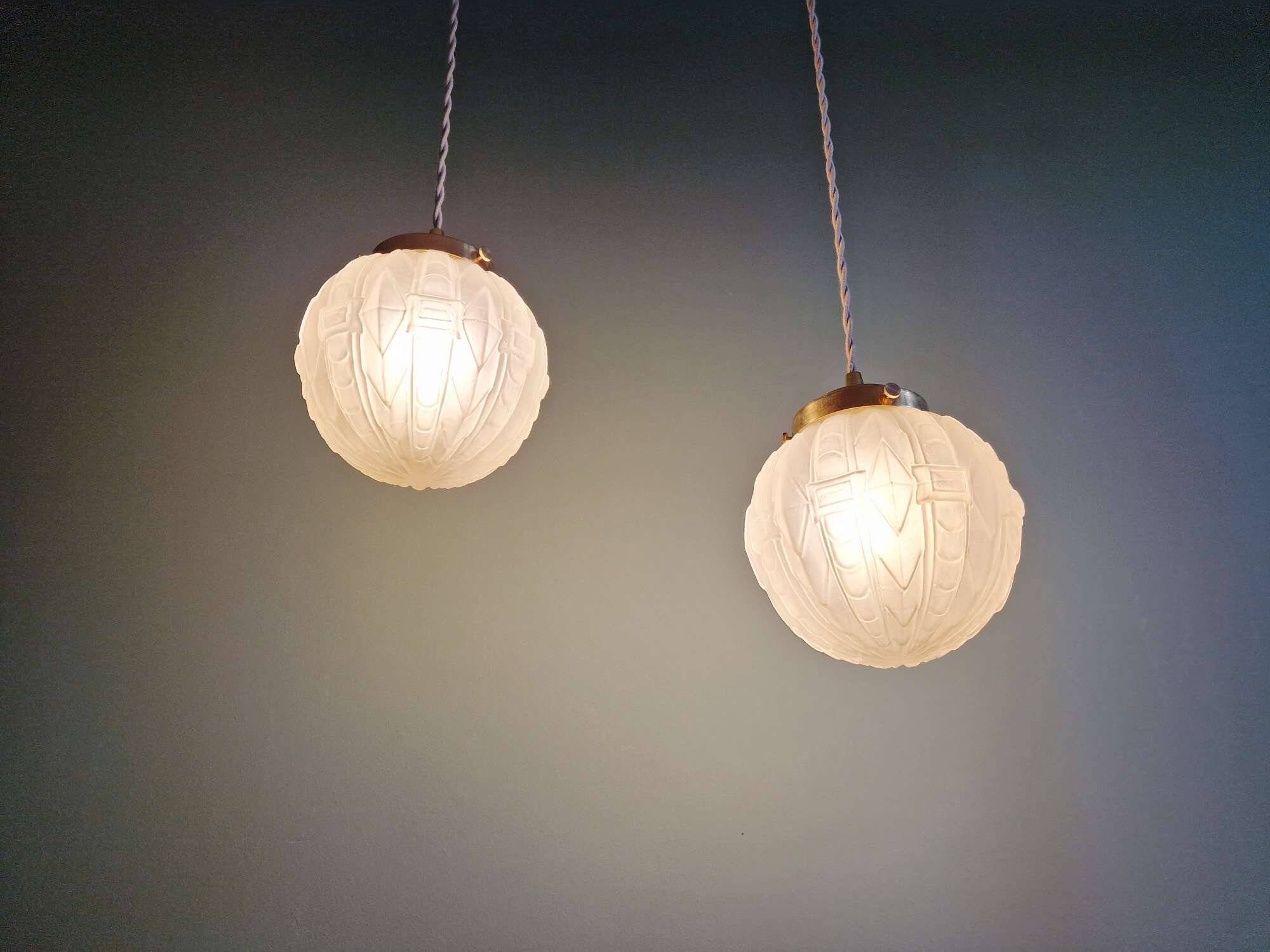 Pair of Art Deco pendant lights in pressed molded satin glass, 1920-30