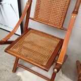 Pair of folding chairs in bamboo and caning, leather and brass