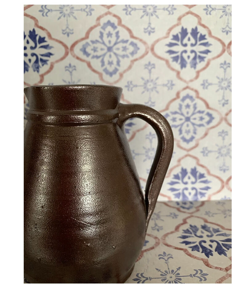 Pitcher in dark brown sandstone