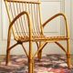 Children's rattan armchair & its old pink skin