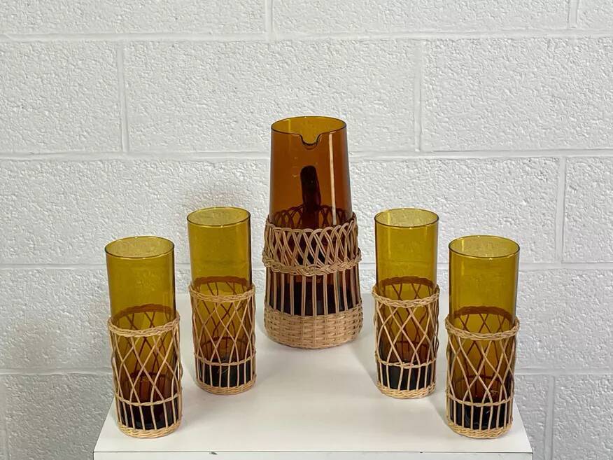 Vintage service for orangeade in amber glass and wicker.