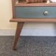 Renovated vintage bedside table in wood, with tapered legs – Matt green & gold background