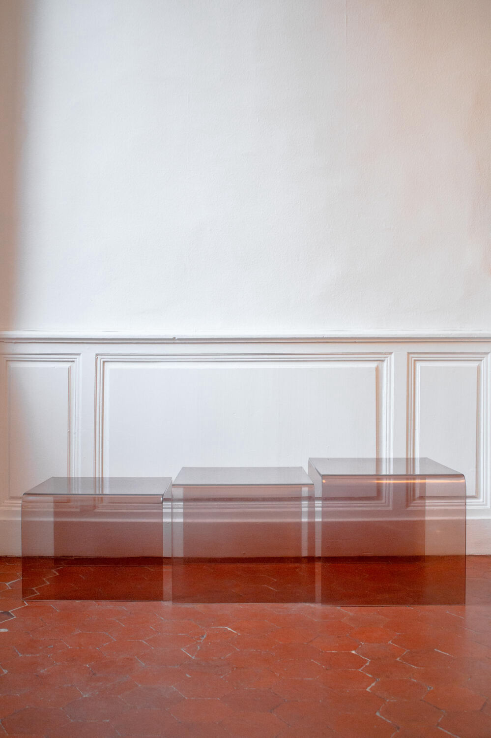 Vintage trio of nesting tables in smoked plexiglass by Michel Dumas, year.