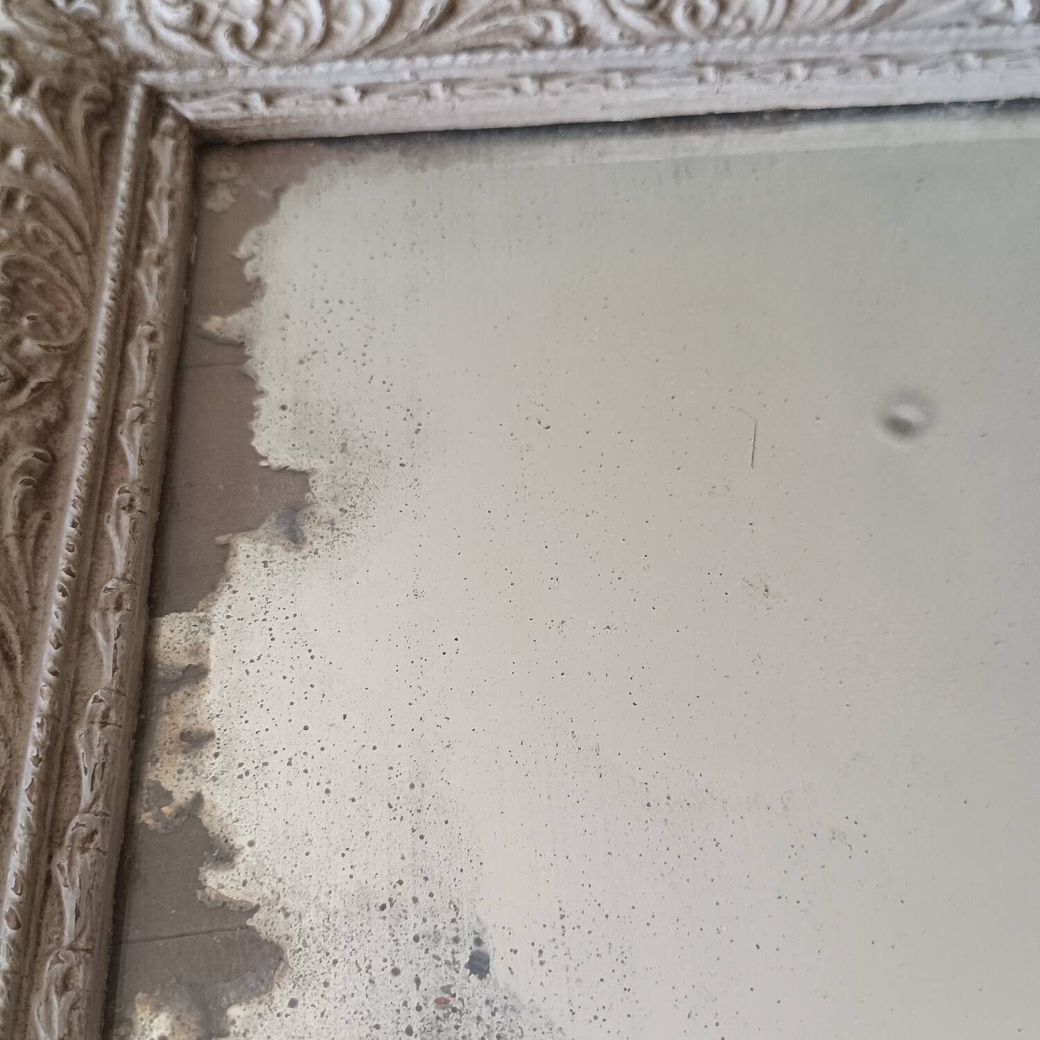 Antique mirror in carved, painted and patinated wood