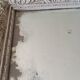 Antique mirror in carved, painted and patinated wood