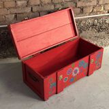 Red wooden trunk with floral patterns