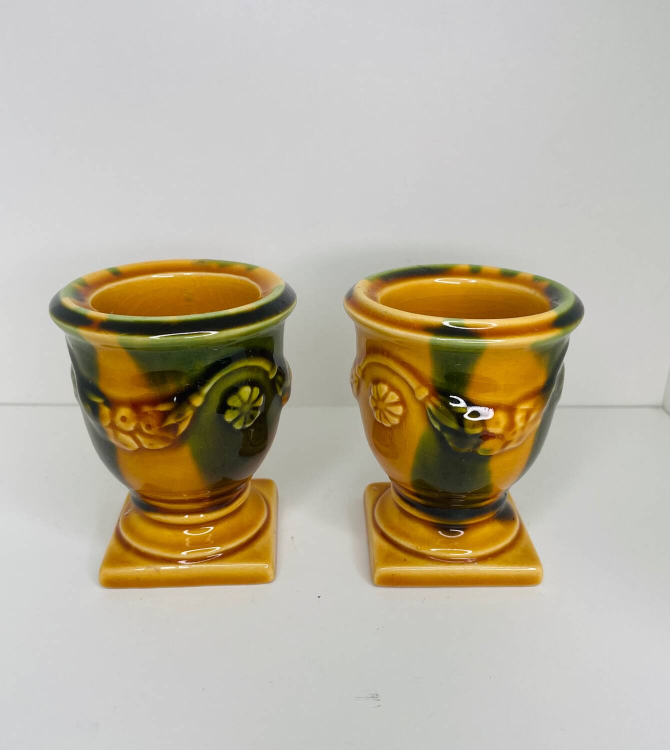 Pair of ocher and green ceramic point-a-line candlesticks