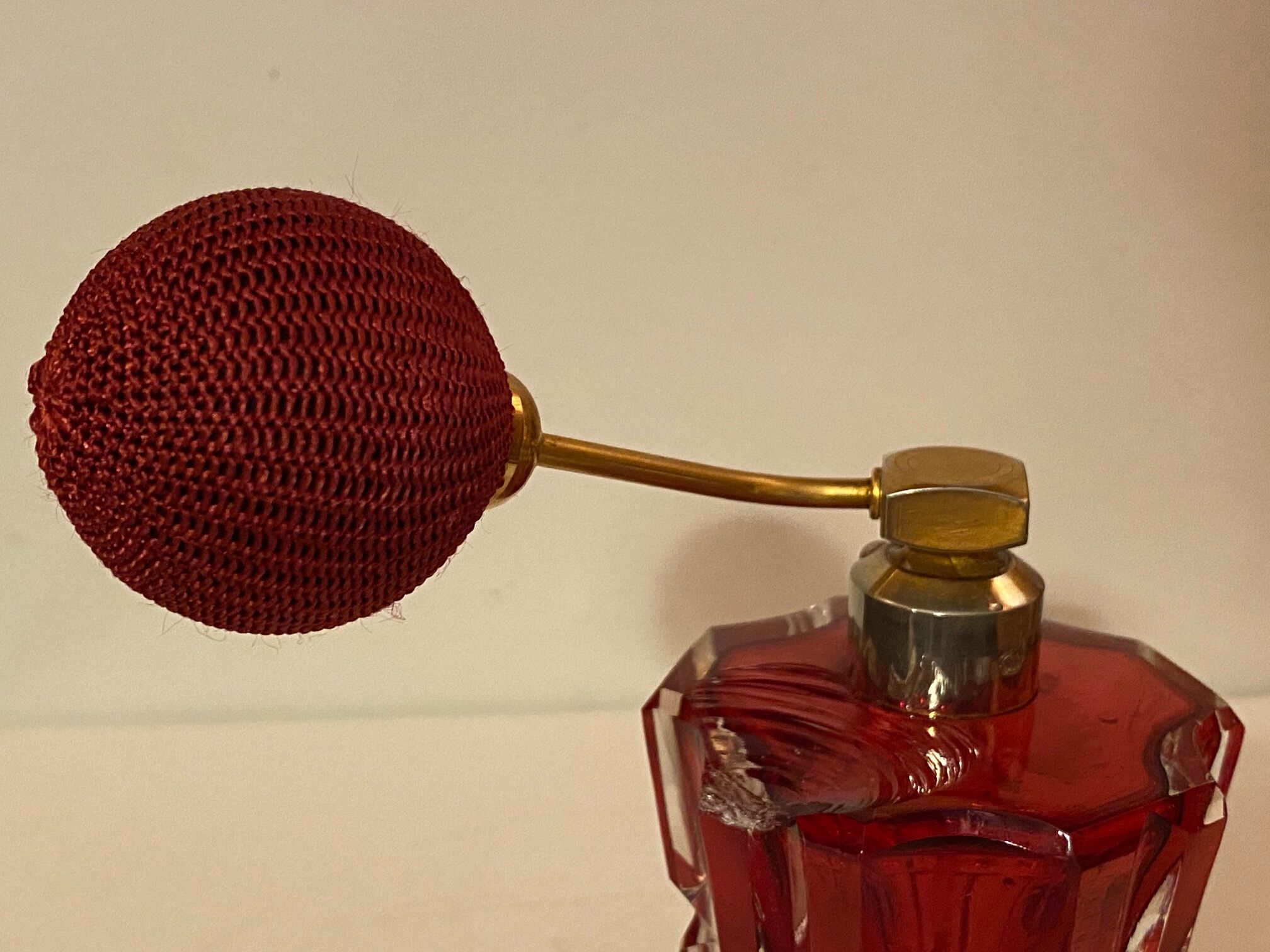 Red crystal perfume spray and red pump.