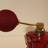 Red crystal perfume spray and red pump.