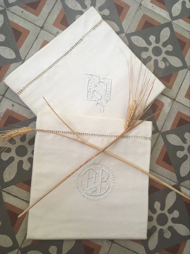 Two matching mixed pillowcases embroidered A B