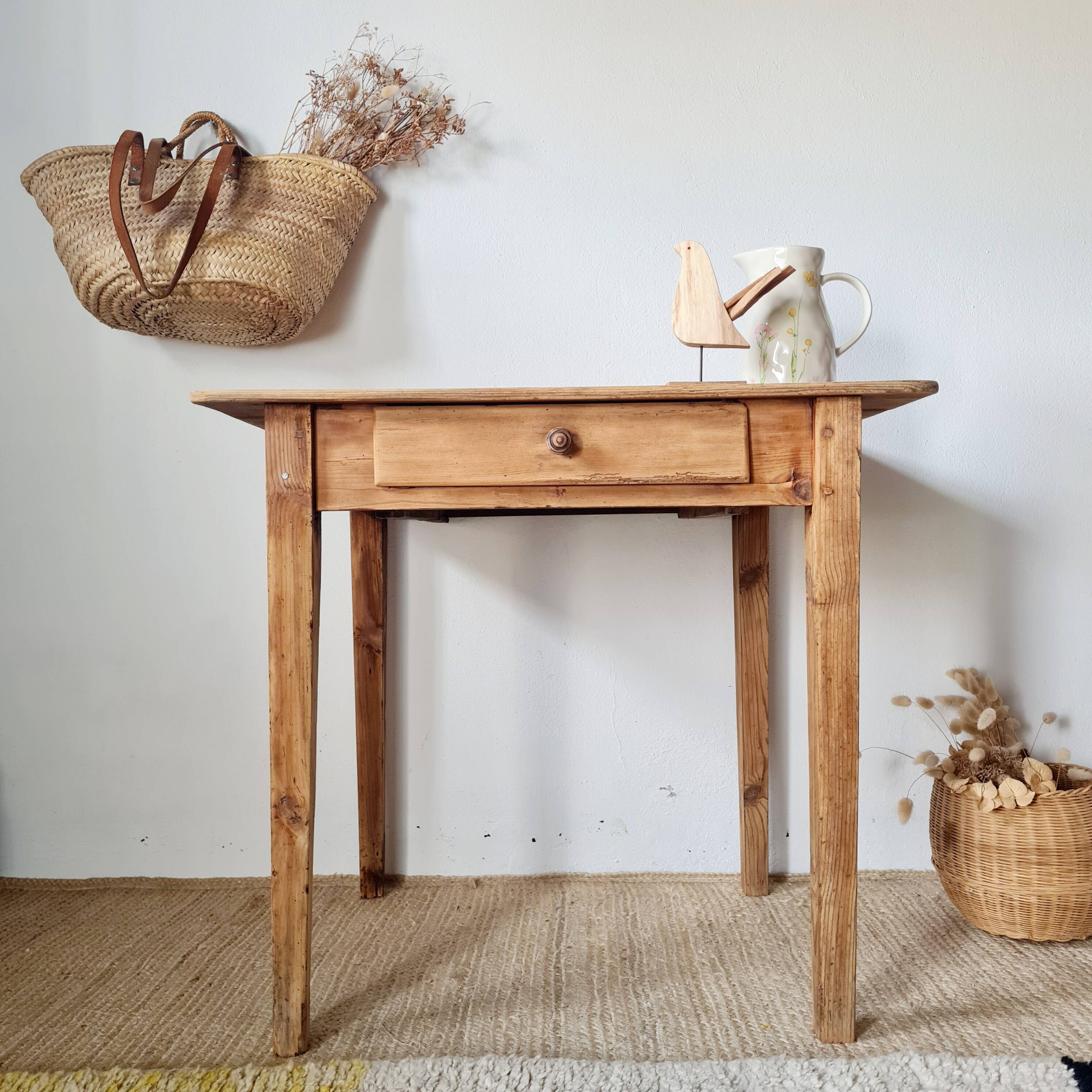 Small old farmhouse table in raw wood.
