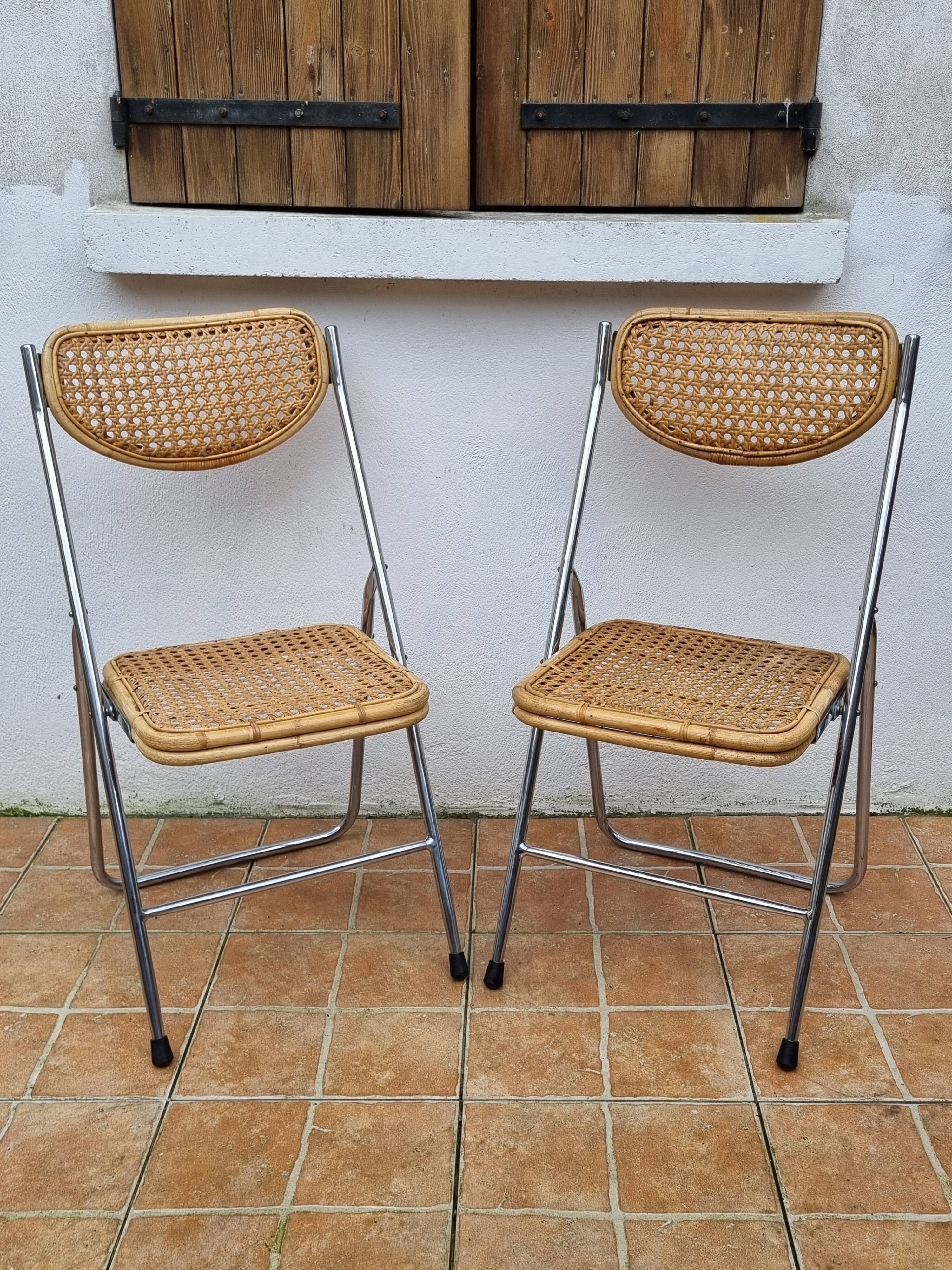 Pair of vintage metal and cane folding chairs