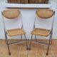 Pair of vintage metal and cane folding chairs