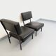Set of 2 vintage modernist armchairs in black faux leather and metal.