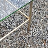 Vintage coffee table in gold and blackened metal with glass top from the 60s