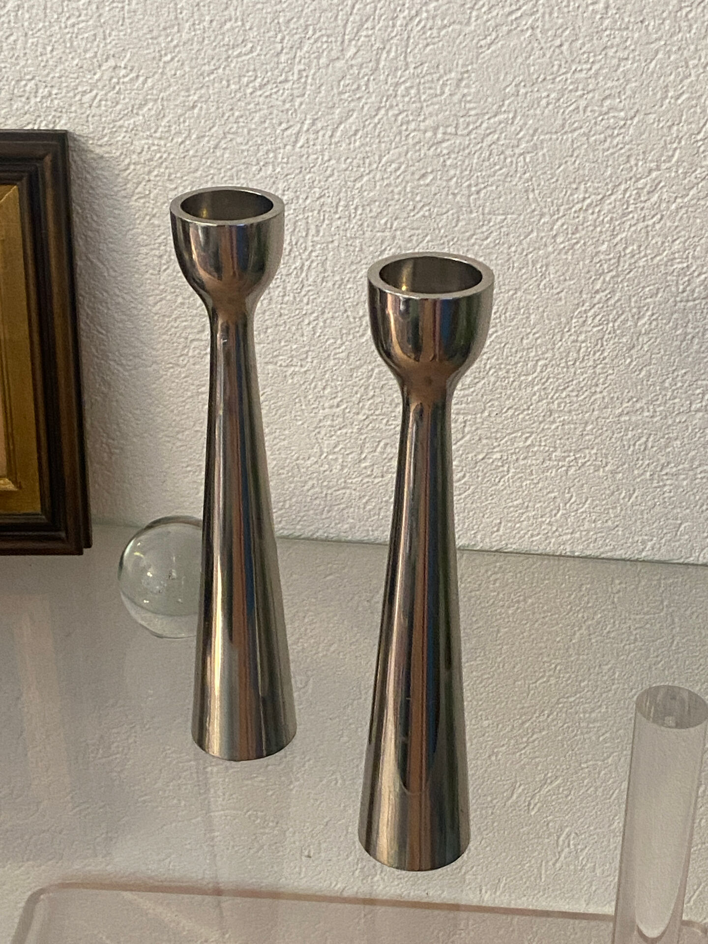Pair of polished aluminium candlesticks