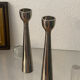 Pair of polished aluminium candlesticks