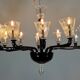 Venetian chandelier in Murano glass in black and colourless, 12 light arms, circa 1990.