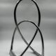 Chromed sculptural art object, abstract modernist shape in metal, contemporary design accent, brutalist interior decoration.