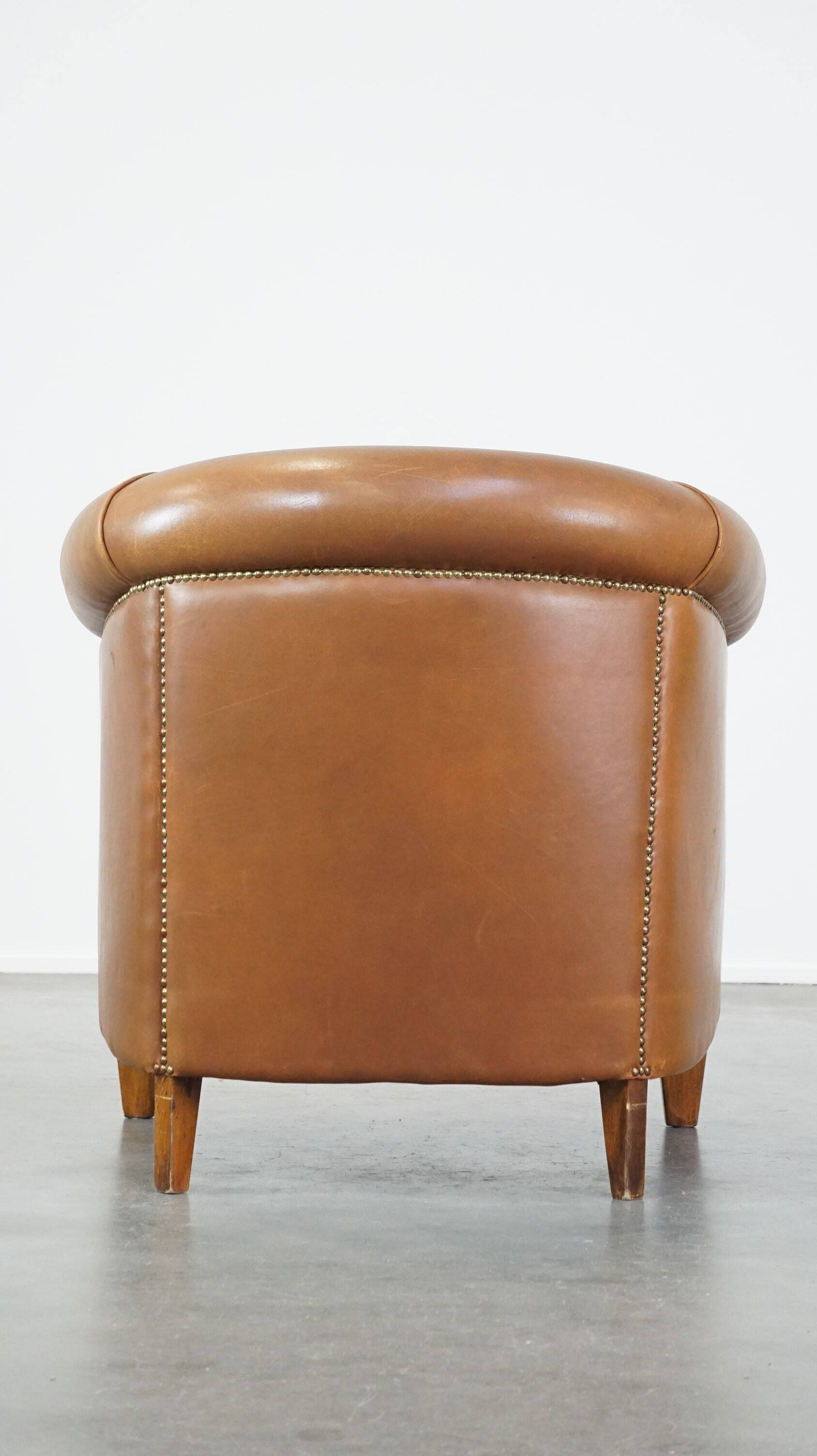 Sheep leather club chair in neutral cognac colour and in good condition