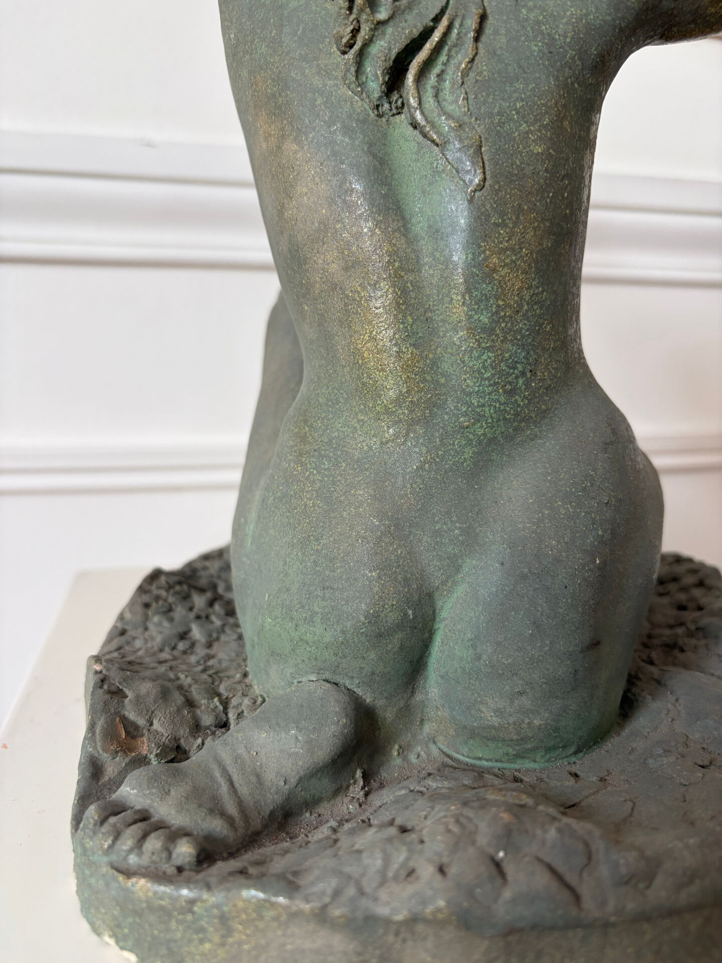 Sculpture of a naked woman titled "Youth" in terracotta.