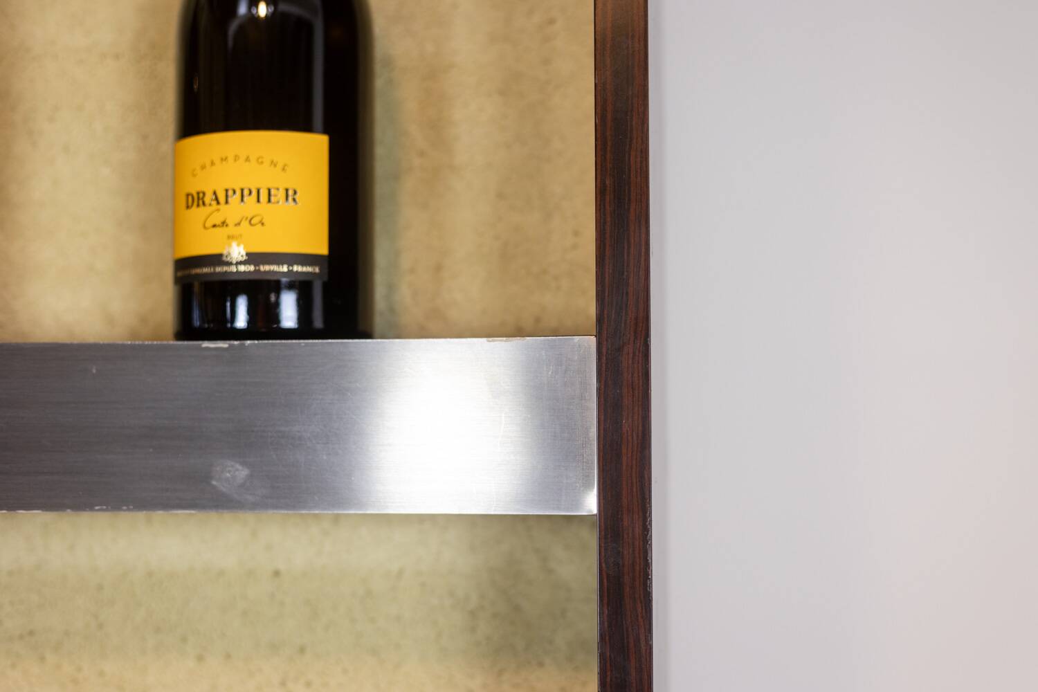 Circular bar in brushed metal, wood and carpet. 1970s.