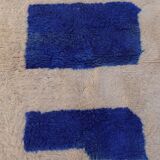 White Moroccan rug with abstract Klein blue patterns
