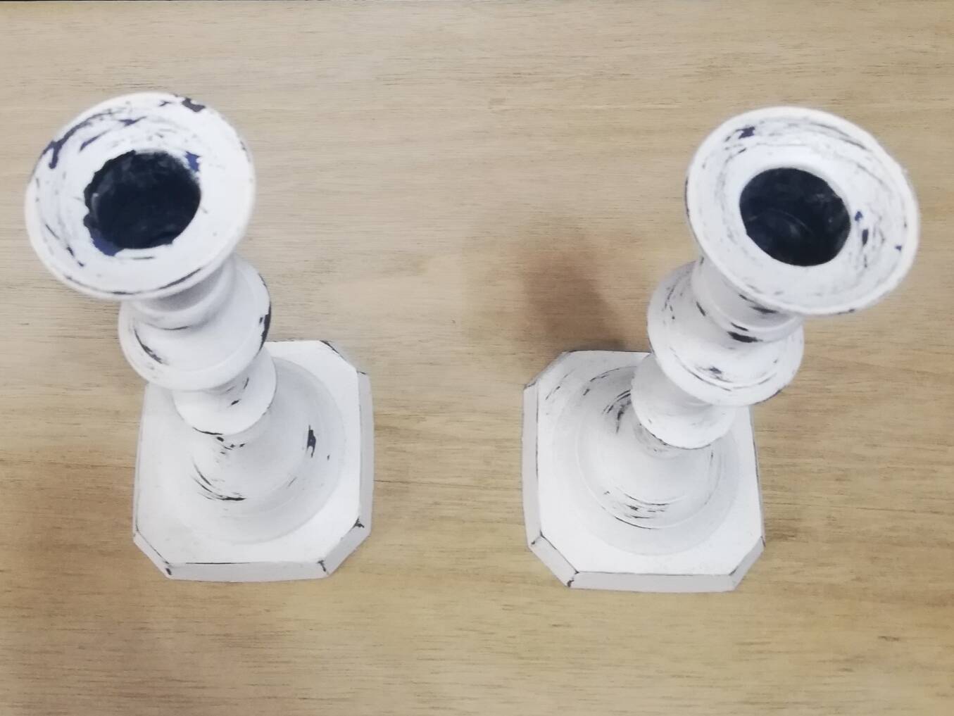 Pair of patinated white candlesticks