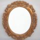 Oval mirror in gilded and carved wood. Vintage mirror. Wall mirror.