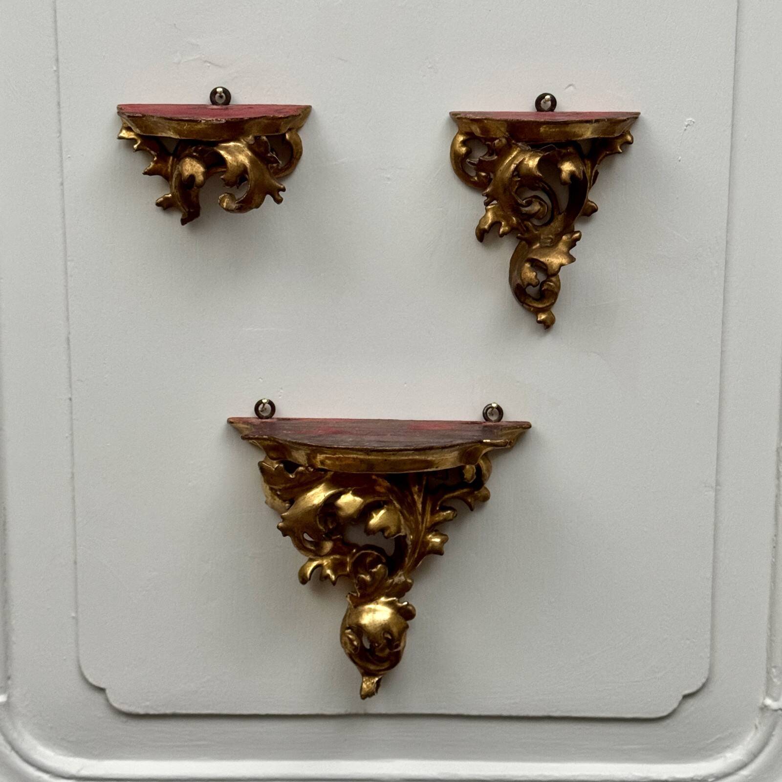 Set of three gilded wood consoles in Rococo style, late 19th century.