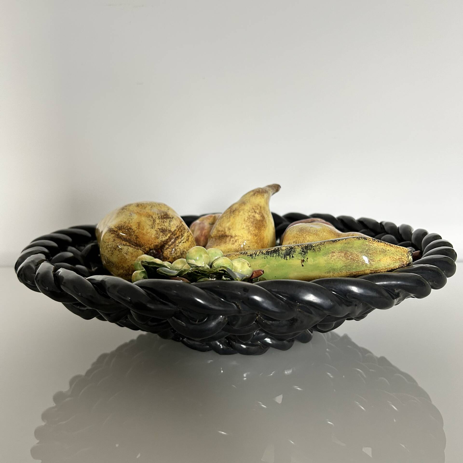 Large woven bowl and trompe l'œil fruits