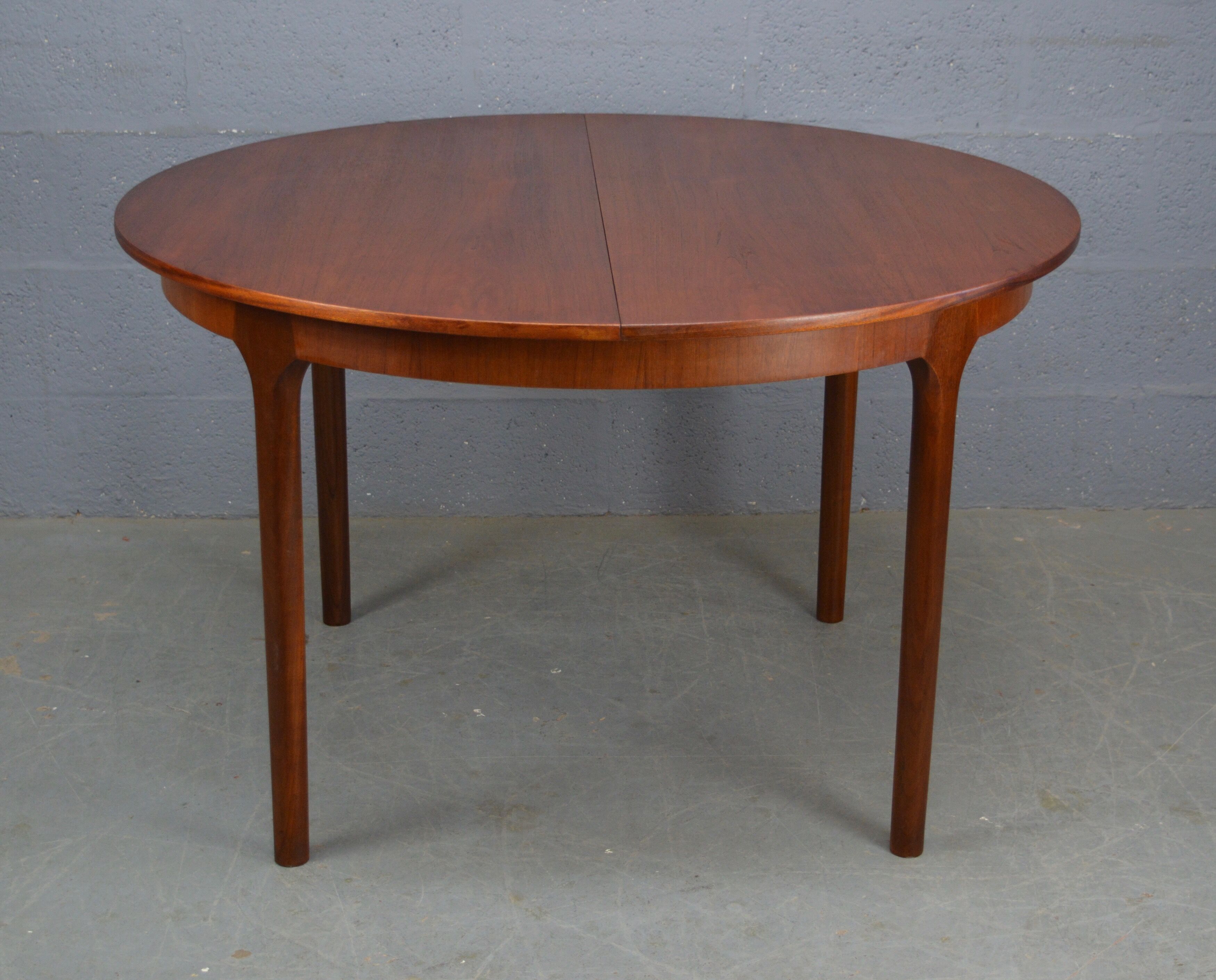 Round teak dinning table and chairs by Mctintosh