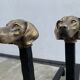 Pair of metal chenets decorated with brass dog heads