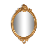 Large oval mirror in gilded wood