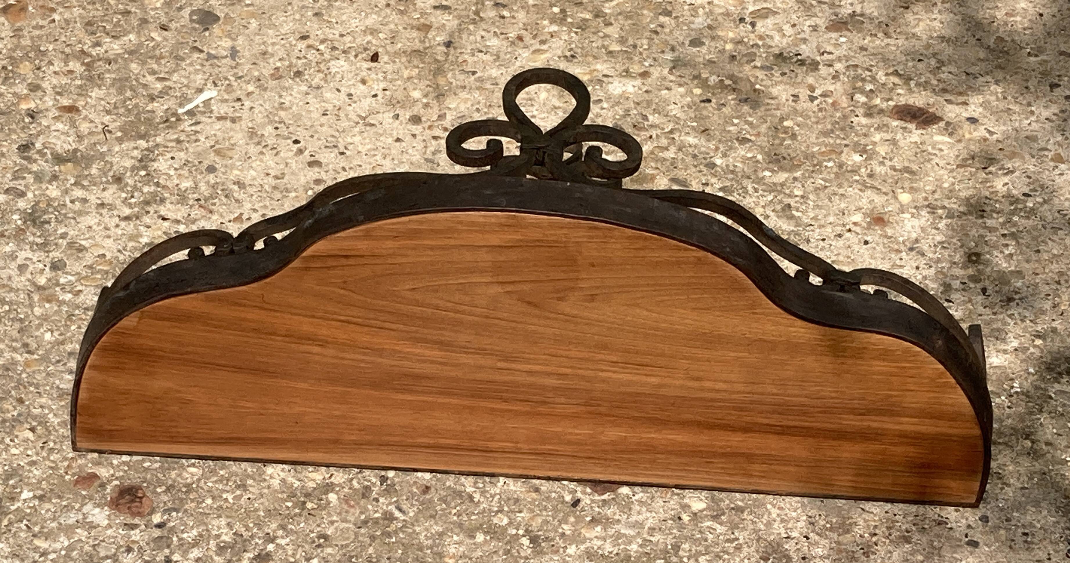 Old wrought iron console with a fleur-de-lis design.