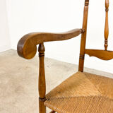 Antique oak and elm wooden armchair with cane seat