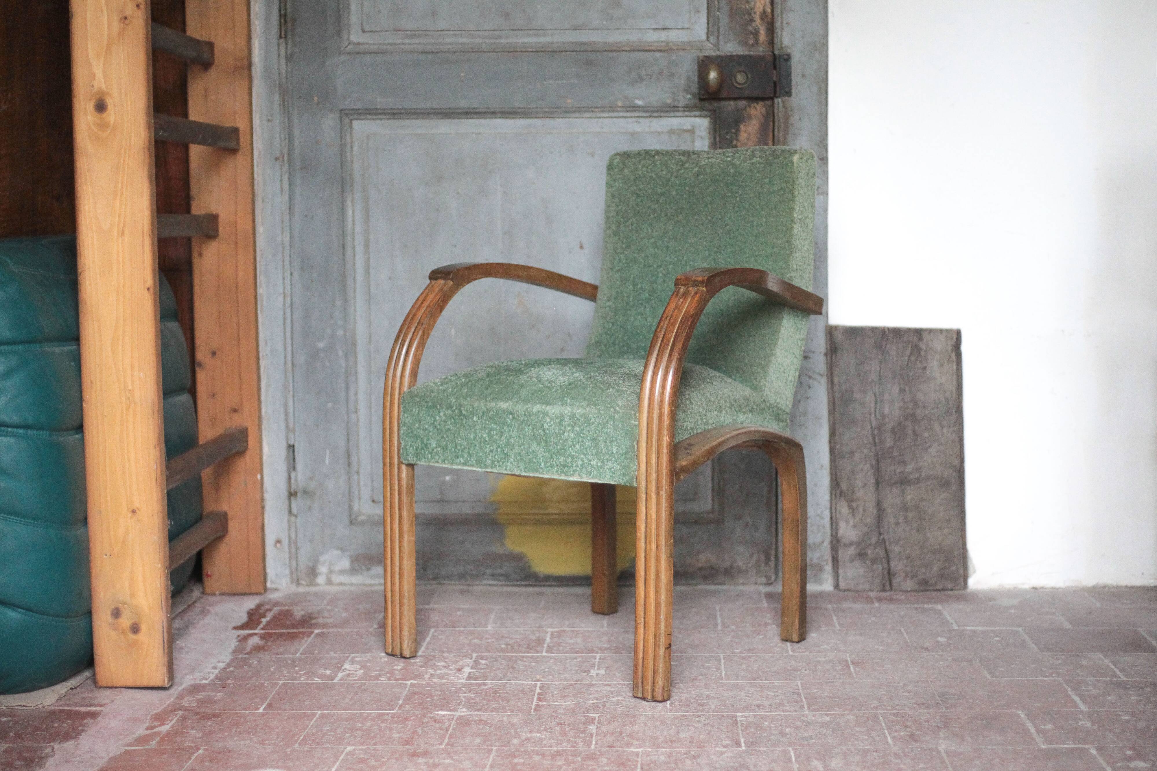 Art Deco armchair in wood and green fabric, living room armchair, interior decor.