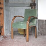 Art Deco armchair in wood and green fabric, living room armchair, interior decor.