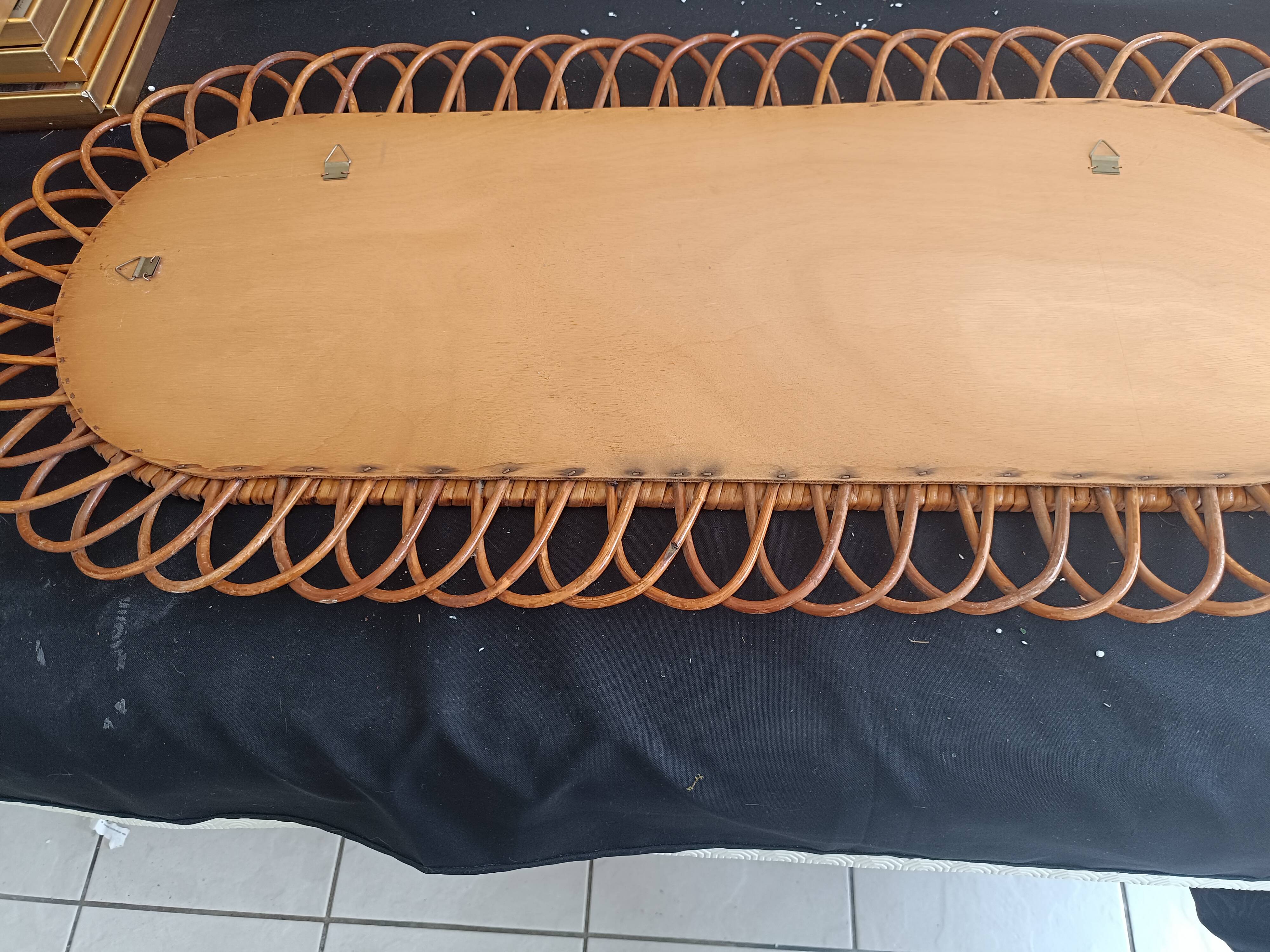 Large oval mirror from the 60s in rattan.
