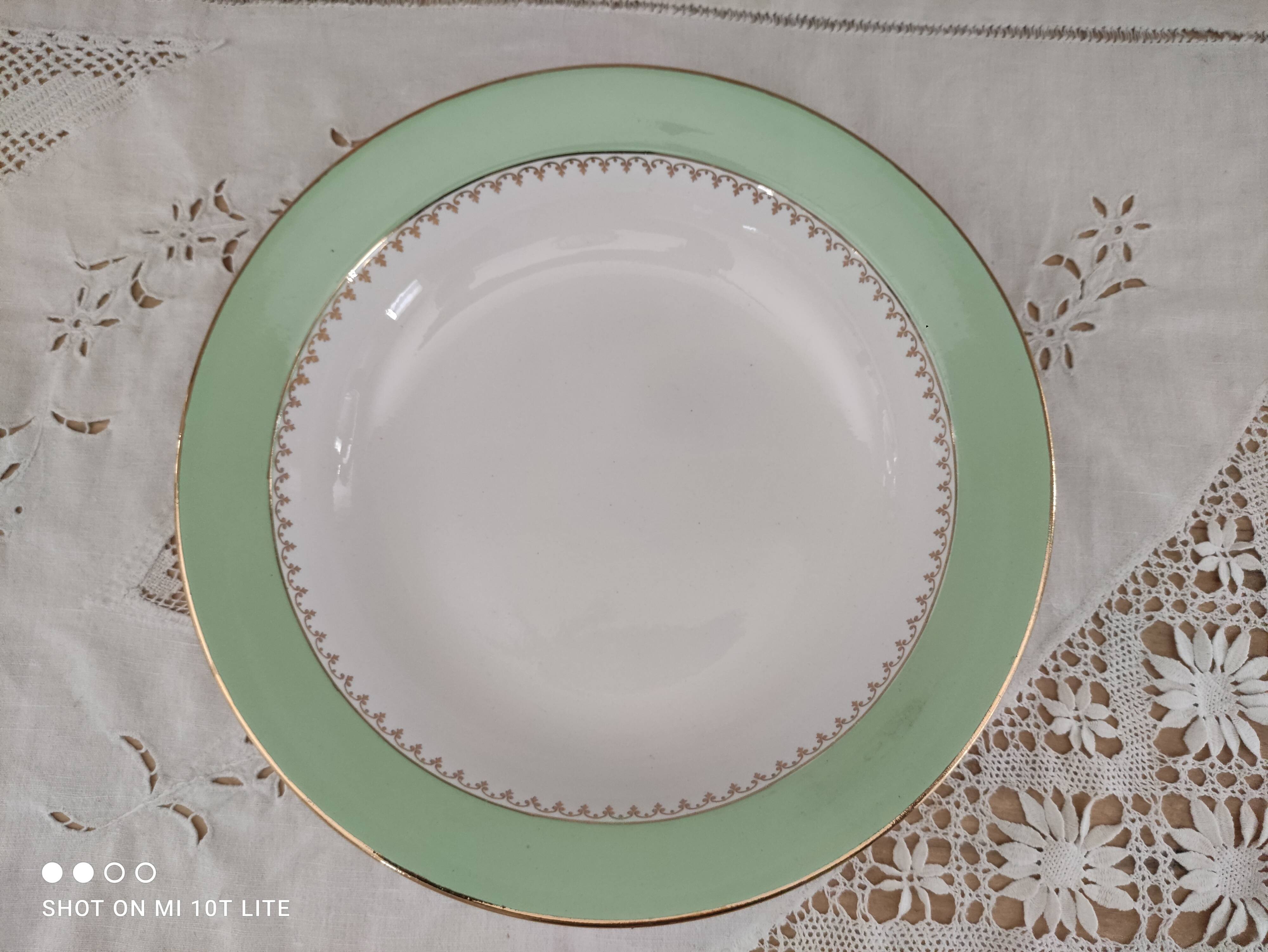 Round hollow plate in water green with a golden frieze, Cafés Lemaire.