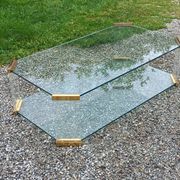 1970s designer coffee table in glass, plexiglass, and gold metal.