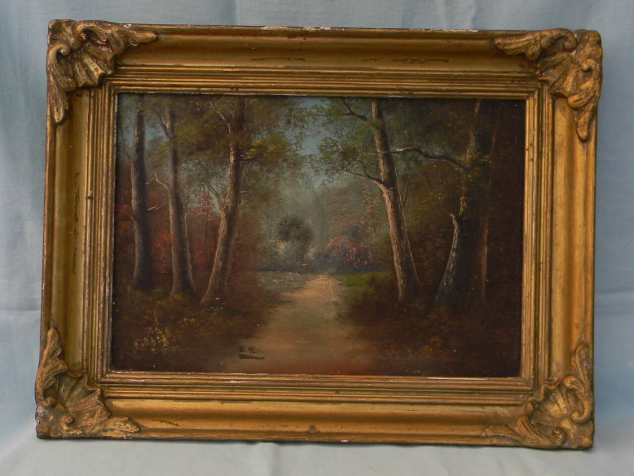 Old signed landscape painting under wood.