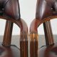 Set of two brown leather Chesterfield dining chairs in English style.