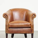 Very comfortable, elegant leather club armchair with a removable seat cushion and timeless design