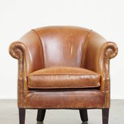 Very comfortable, elegant leather club armchair with a removable seat cushion and timeless design