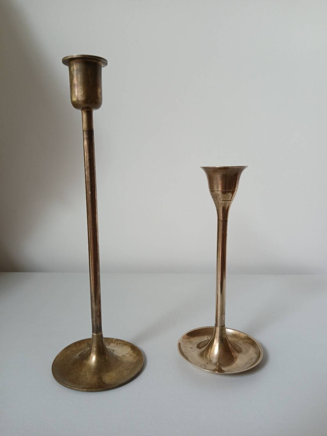 Set of two straight brass candlesticks.