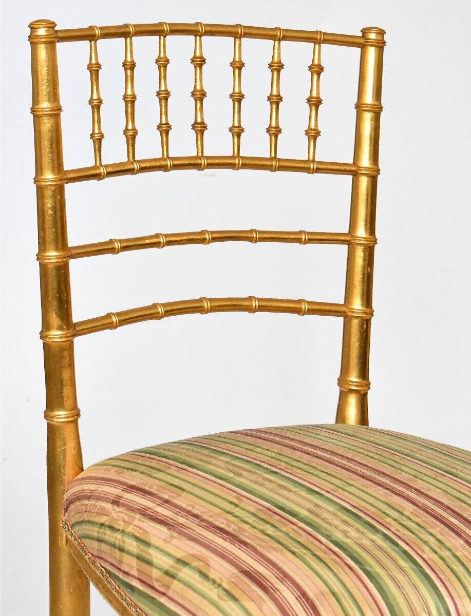 Pair of golden wood chairs in a bamboo style.